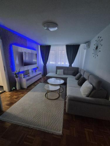 a living room with a couch and a table at Nella Apartment in Sarajevo