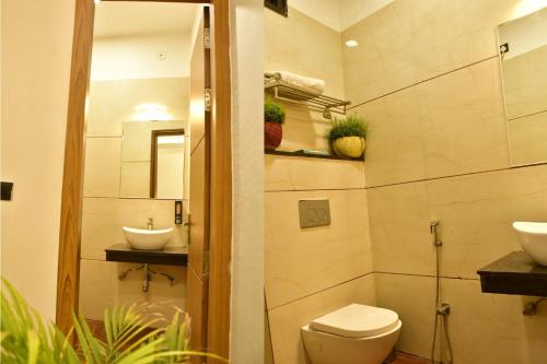 a bathroom with a toilet and a sink at Hotel 7-B in Chhatarpur