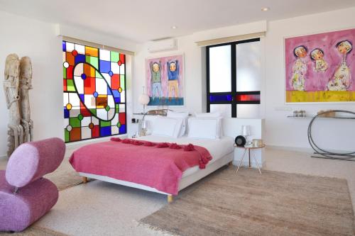 a bedroom with a bed and a stained glass window at Dar Syada Boutique Hotel Marrakech in Marrakech