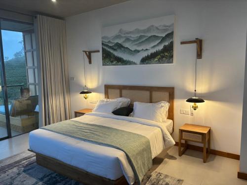 a bedroom with a bed and a large window at Lord's Haputale in Haputale