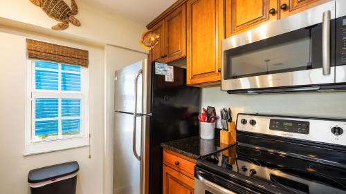 a kitchen with a refrigerator and a microwave at Key Largo Baha Penthouse Ocean Pointe 1416 in Key Largo