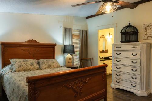a bedroom with a bed and a dresser and a ceiling fan at Lakefront Farm House - 34 in Mead