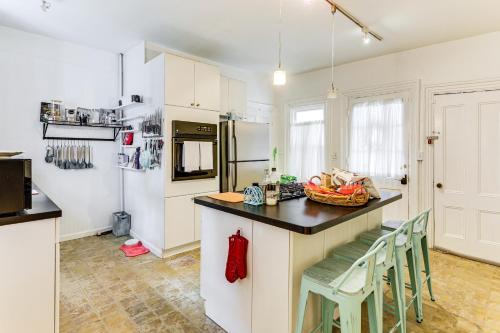 a kitchen with white cabinets and a counter with chairs at 1 Mi to Needham Center Square Pet-Friendly Apt! 