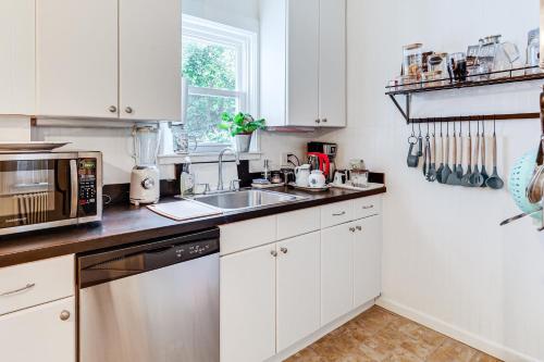a kitchen with white cabinets and a sink at 1 Mi to Needham Center Square Pet-Friendly Apt! 