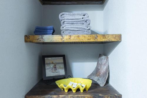 a shelf with a yellow bowl on a wall at Lakefront Dockside Cabin - 35 in Mead