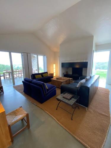 a living room with blue couches and a fireplace at Monte do Álamo da Serra in Redondo