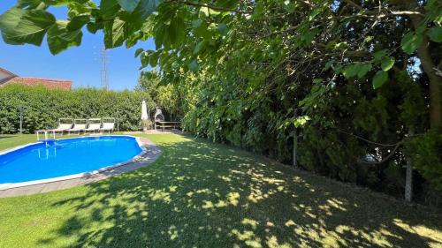 a swimming pool in a yard with grass and trees at Villetta Tinmar Barbie House Verona in Verona