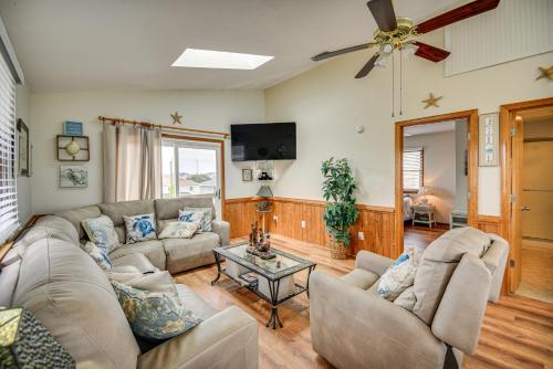 a living room with couches and a flat screen tv at Walk to Beach and Restaurants Outer Banks Retreat in Kill Devil Hills
