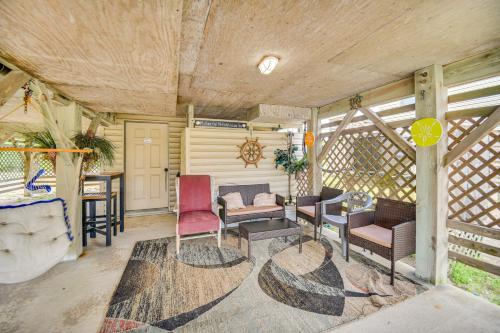 a living room with chairs and a couch and a table at Walk to Beach and Restaurants Outer Banks Retreat in Kill Devil Hills