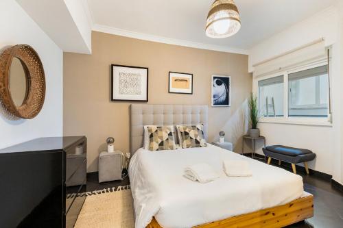 a bedroom with a bed and a flat screen tv at Apartamento - Parque do Jamor in Cruz Quebrada