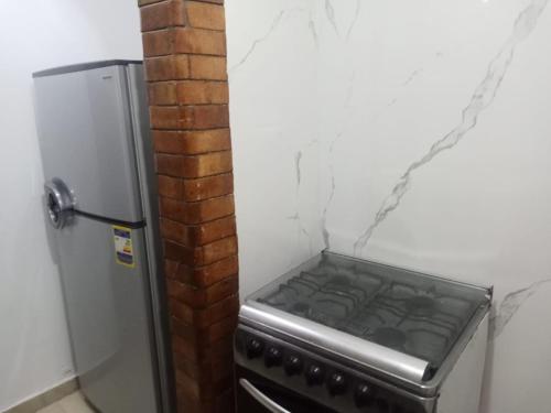 einen Herd in einer Küche neben einem Kühlschrank in der Unterkunft Chalets4A sea and pool view 2Bed rooms without lounge 114 at Green Beach in El-Alamein