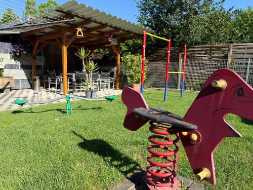 a playground with a play equipment in the grass at Ferienwohnungen Abendsonne - 8 Gehminuten zum EP in Rust