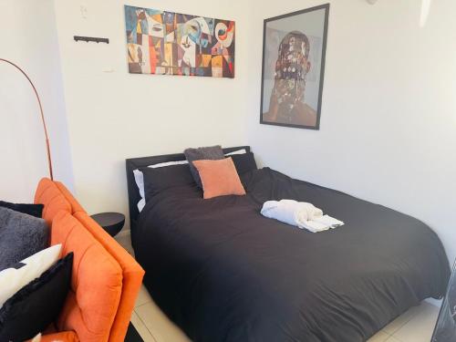 a bedroom with a black bed with a stuffed animal on it at Smart Artistic studio in shoreditch in Moffat