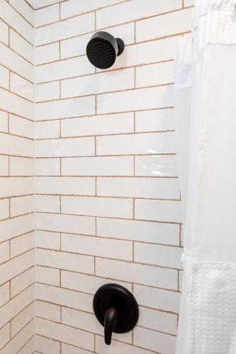 a white brick wall with two lights on it at HomeField Inn in Sandusky