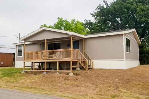 a house with a large deck on the side of it at Lakefront Texoma Harbor - 33 in Mead