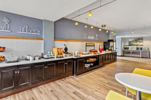 a large kitchen with a counter and a table at Hampton Inn Princeton in Princeton