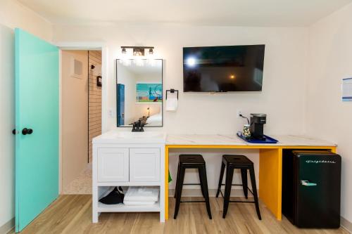 a bathroom with a counter with a sink and a mirror at HomeField Inn in Sandusky