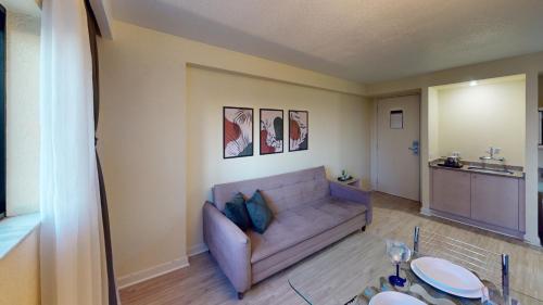a living room with a couch and a table at Ambassador Residence Apart-hotel in Curitiba