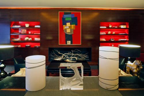 a living room with a fireplace and a table at Warwick Champs-Elysées Paris in Paris