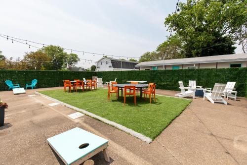 a patio with a table and chairs on grass at HomeField Inn in Sandusky