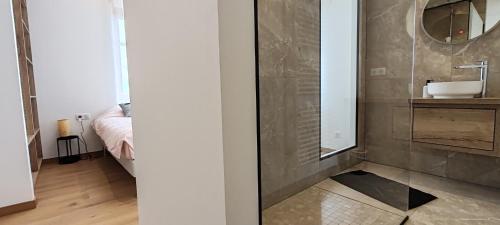 a bathroom with a sink and a mirror at La maison des vignerons - Le Praelatenberg in Orschwiller