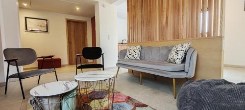 a living room with a couch and two chairs at La maison des vignerons - Le Praelatenberg in Orschwiller