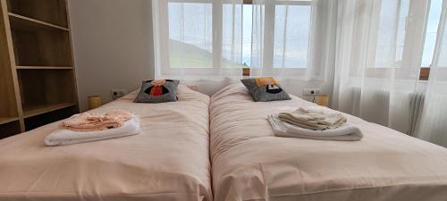 a bedroom with two beds with towels on them at La maison des vignerons - Le Praelatenberg in Orschwiller