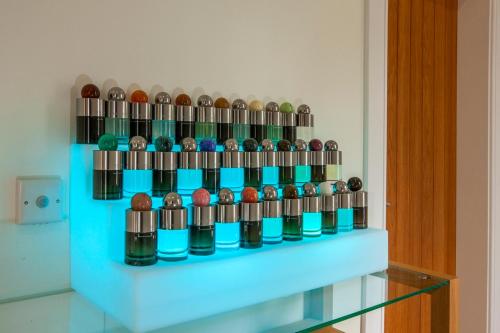 a display of different colored bottles on a shelf at Ardtorna in Benderloch