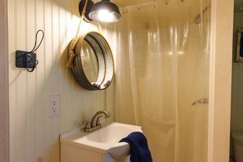 a bathroom with a sink and a mirror and a shower at Lake Access Sunshine Suite - 30 in Mead