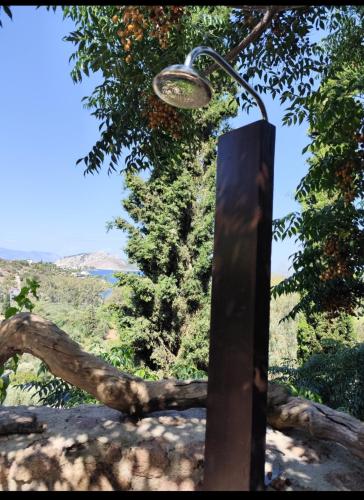 a street light on a pole with an orange tree at new serenity villa aegina in Aegina Town
