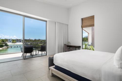 a bedroom with a large bed and a large window at South Bank in Long Bay Hills