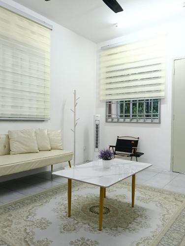 a living room with a couch and a coffee table at Air Puteri Rest House in Mersing