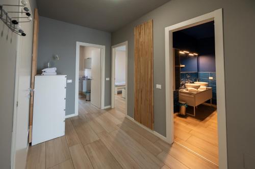 a hallway with a living room and a bathroom with a sink at Italian Vacation Homes - Easy Living Iseo Lake in Predore