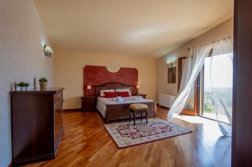 a bedroom with a bed and a large window at Villa Mira Exclusive with Pool- Noto Sicily in Noto Marina