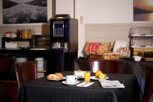a table with a plate of food on it at Hotel Vigo Plaza in Vigo