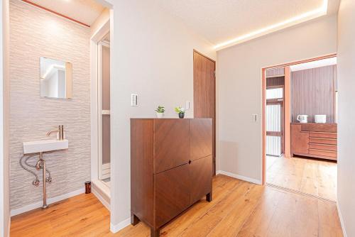 a bathroom with a sink and a cabinet in a room at Asuka Guesthouse 宿-飛鳥 in Tokyo