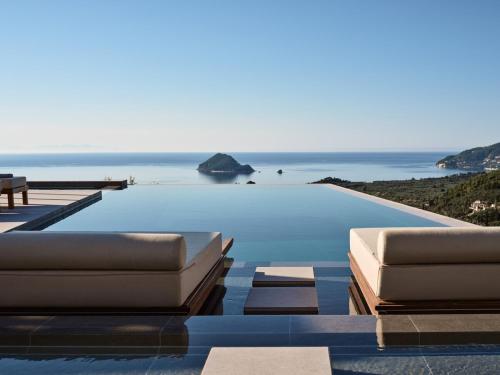 a swimming pool with a view of the ocean at Marisia Luxury Villa, An Acre of Endless Blue in Lithakia