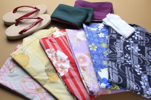 a pile of ties sitting on a table next to shoes at Bettei Koyoi - Adult Only in Hakone