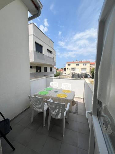 a patio with a table and chairs on a balcony at Azure Dream in Razvala