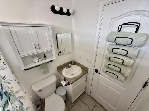 a small bathroom with a toilet and a sink at Charming Provo Home close to BYU and Utah Lake in Provo