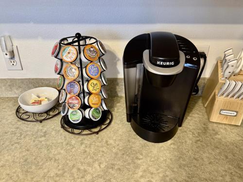 a coffee maker sitting on top of a counter next to a cup at Charming Provo Home close to BYU and Utah Lake in Provo