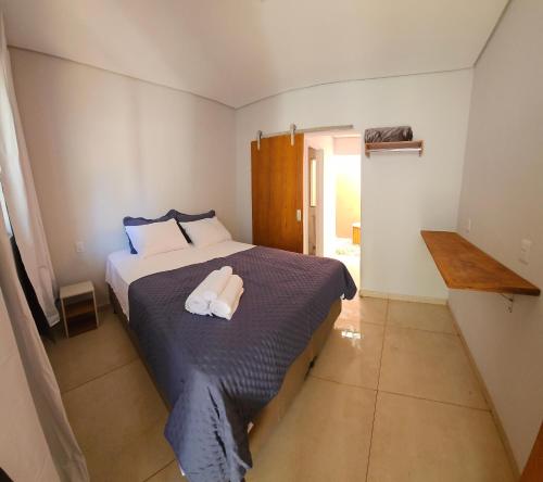 a bedroom with a bed with a towel on it at Pousada Viva Paraíso in Alto Paraíso de Goiás