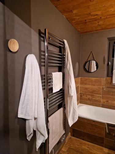 a bathroom with a bath tub and a towel rack at chaleureux cocon dans les alpes in Le Monêtier-les-Bains