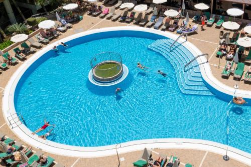 an overhead view of people swimming in a large swimming pool at GF Fañabe in Adeje