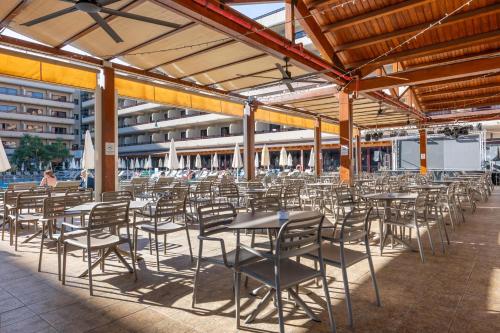 a group of tables and chairs in a building at GF Fañabe in Adeje