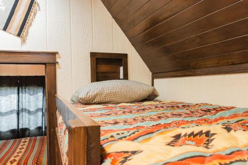 a bed with a comforter and a pillow on it at Cabana Del Lago - 39 in Mead