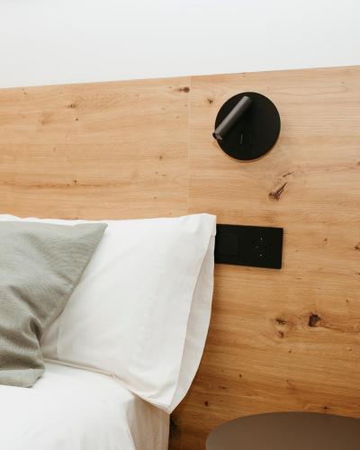 a bed with a white pillow and a mouse on a wall at Hostal Ainhoa in Tafalla