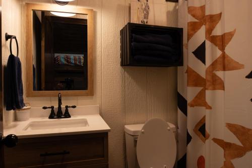 a bathroom with a sink and a toilet and a mirror at Cabana Del Lago - 39 in Mead