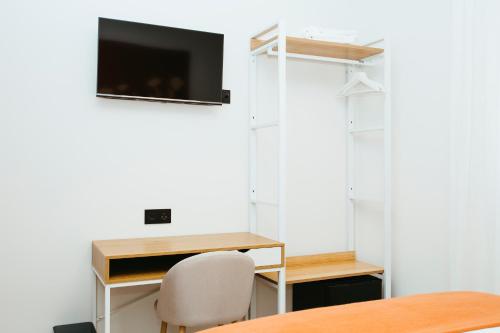a room with a desk and a tv on a wall at Hostal Ainhoa in Tafalla
