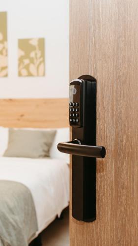 a wooden door with a phone sticking out of it at Hostal Ainhoa in Tafalla